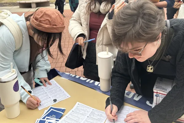 student workers at MUWU signing union cards