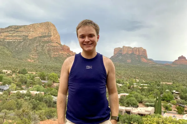 Eliot Berk standing in front of a scenic background