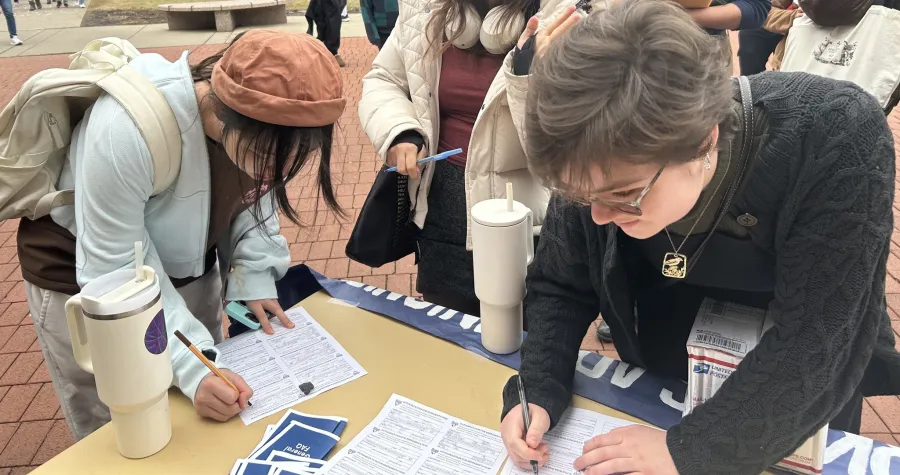 student workers at MUWU signing union cards